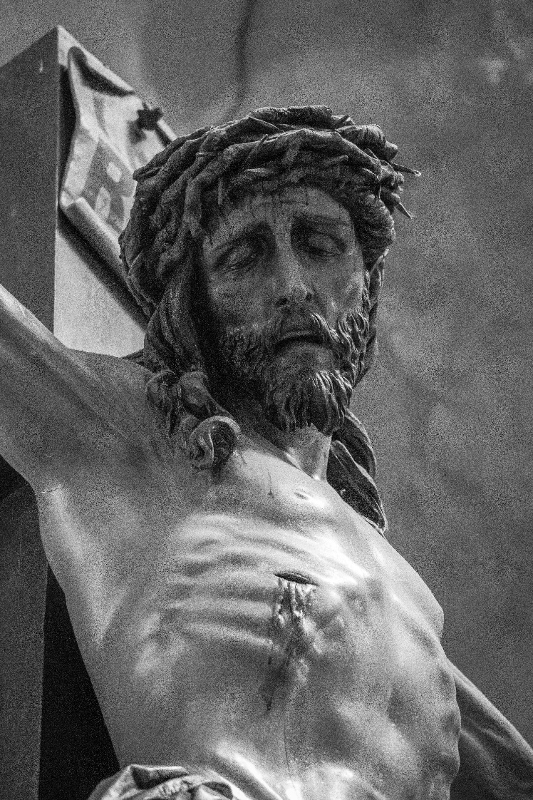 A black and white photo of a statue of jesus