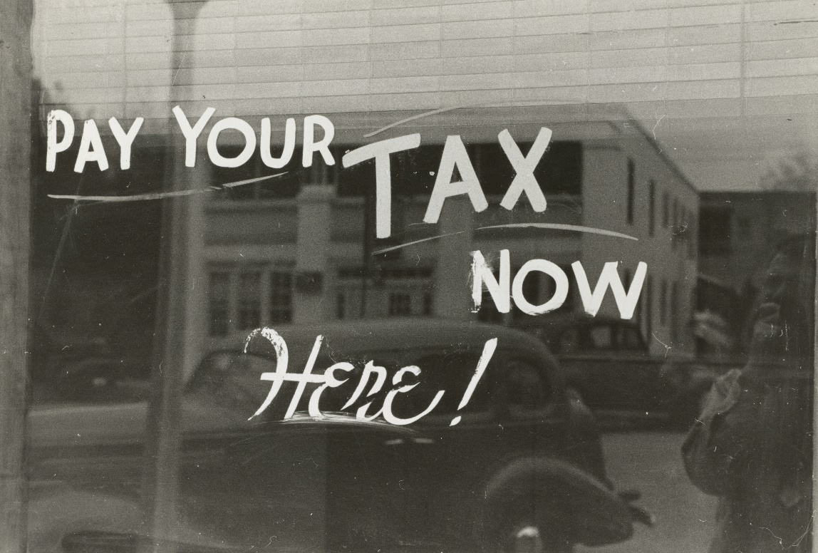 a sign that says pay your tax now here
Sign, Harlingen, Texas. 1939. Photographer Lee Russell