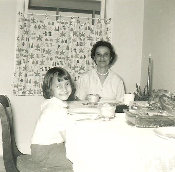 Childhood photo showing a young person dressed for a family dinner